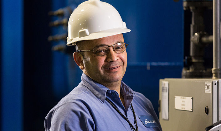 Side view of a Micron employee wearing safety equipment.