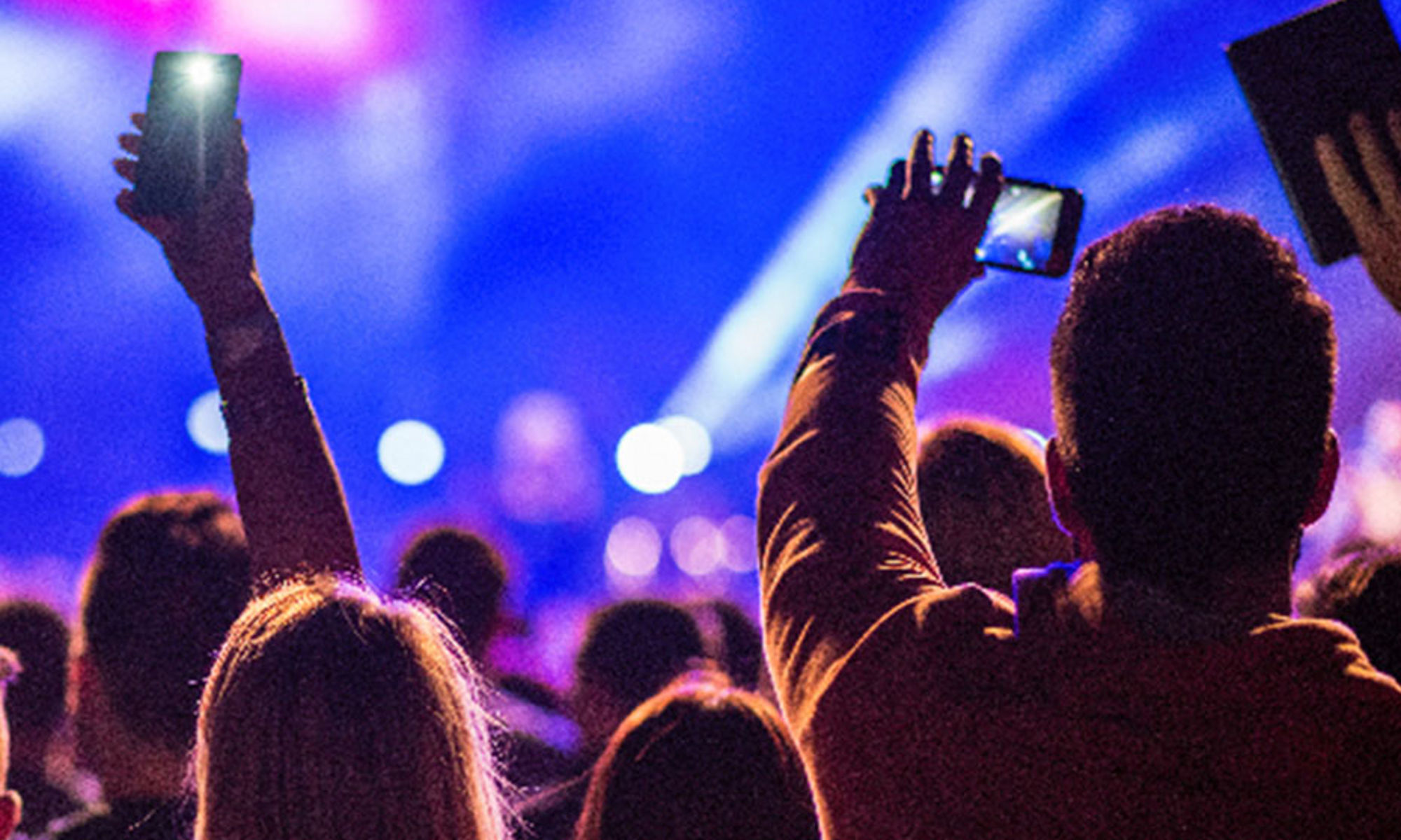 crowd of people at concert holding phones