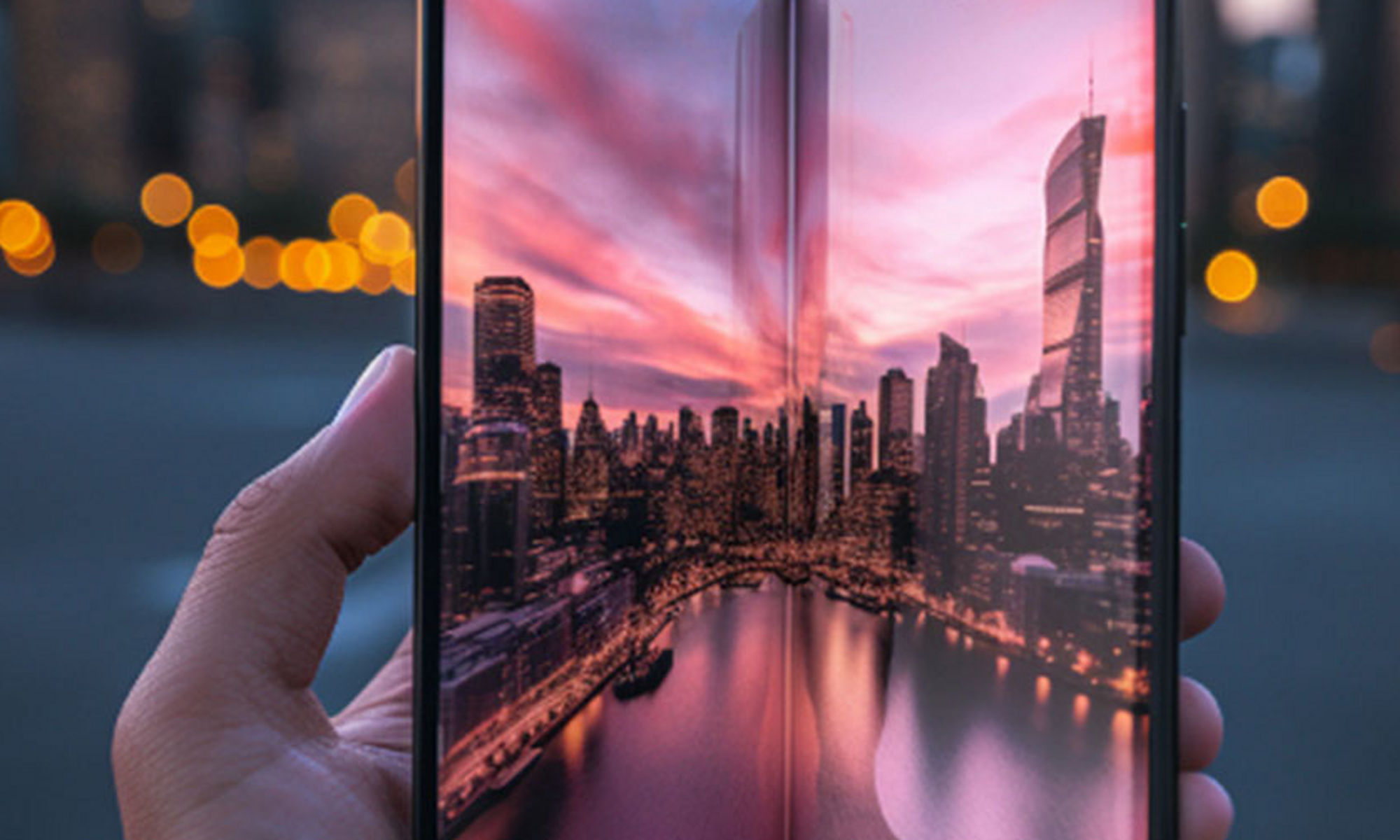 Mobile flip phone with large screen of a city during a sunset