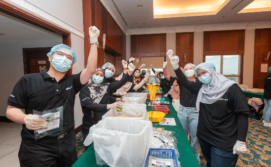 Image of men and women cheering infront of a table