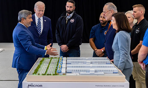 Micron Chairman, President and CEO Sanjay Mehrotra with President Joe Biden and few others showing the blueprint of the infrastructure