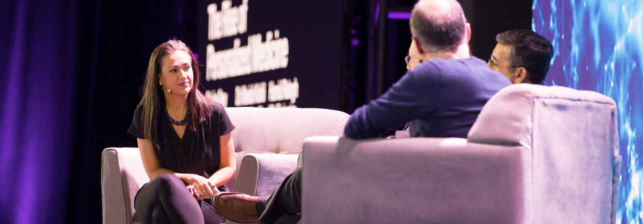 man and woman on a stage discussing a tech related topic