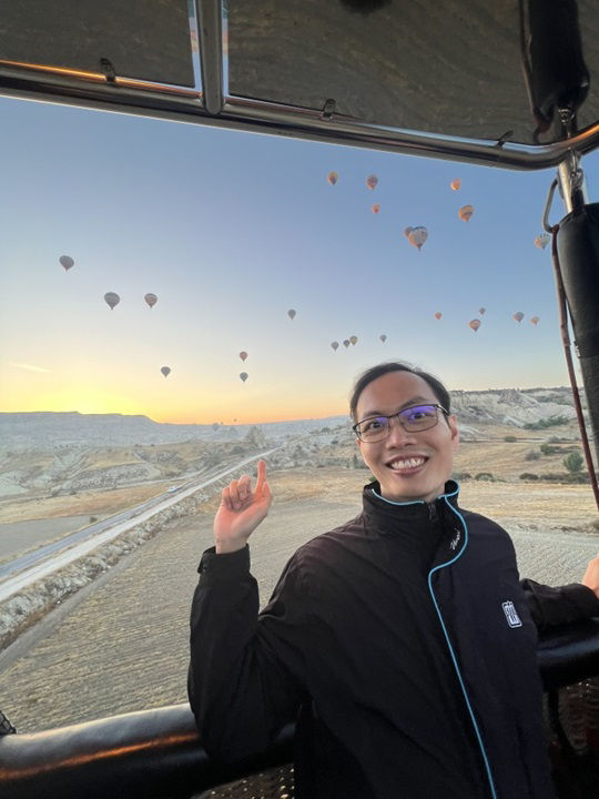 author with view of hot air baloons