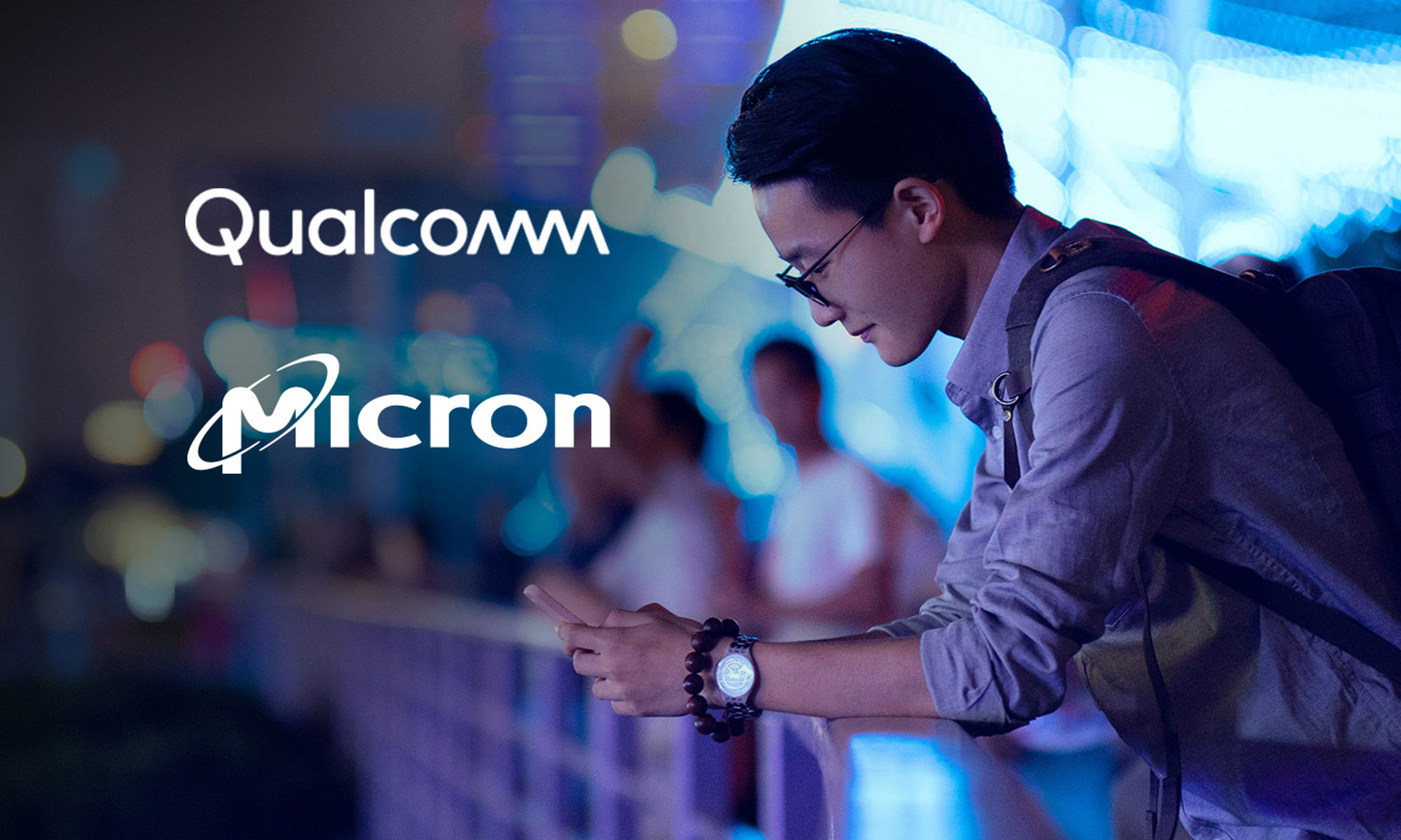 Qualcomm and Micron logos against a blurred background and a young male in the foreground, leaning over a railing, looking at his cell phone