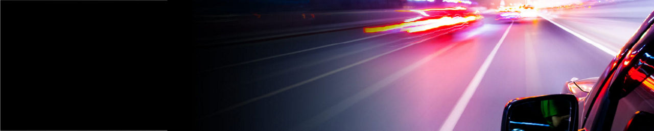 SAFER - Functional Safety. Vehicle moving forward through streaks of light.