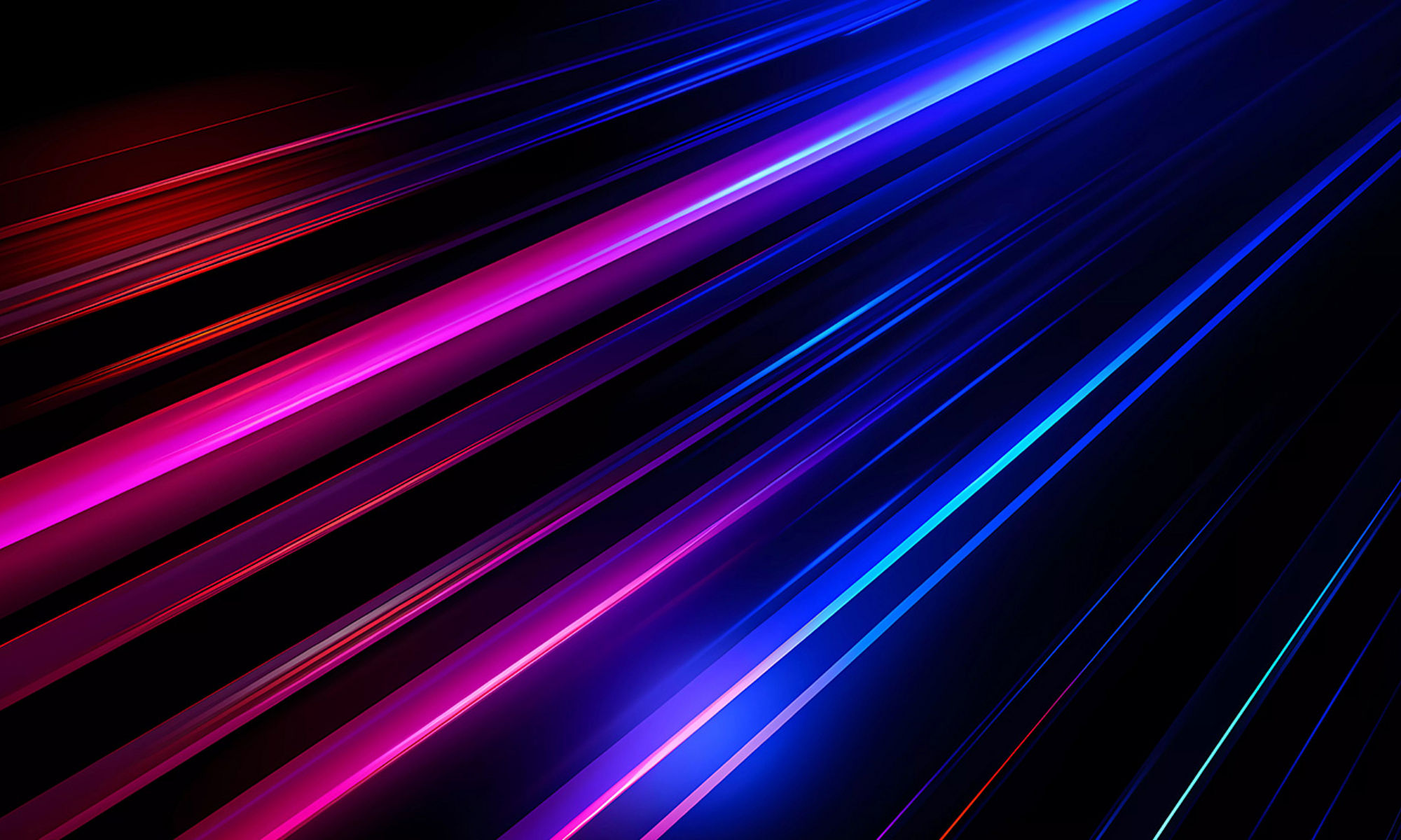 Left to right streaks of blue, pink and red lights on a black background