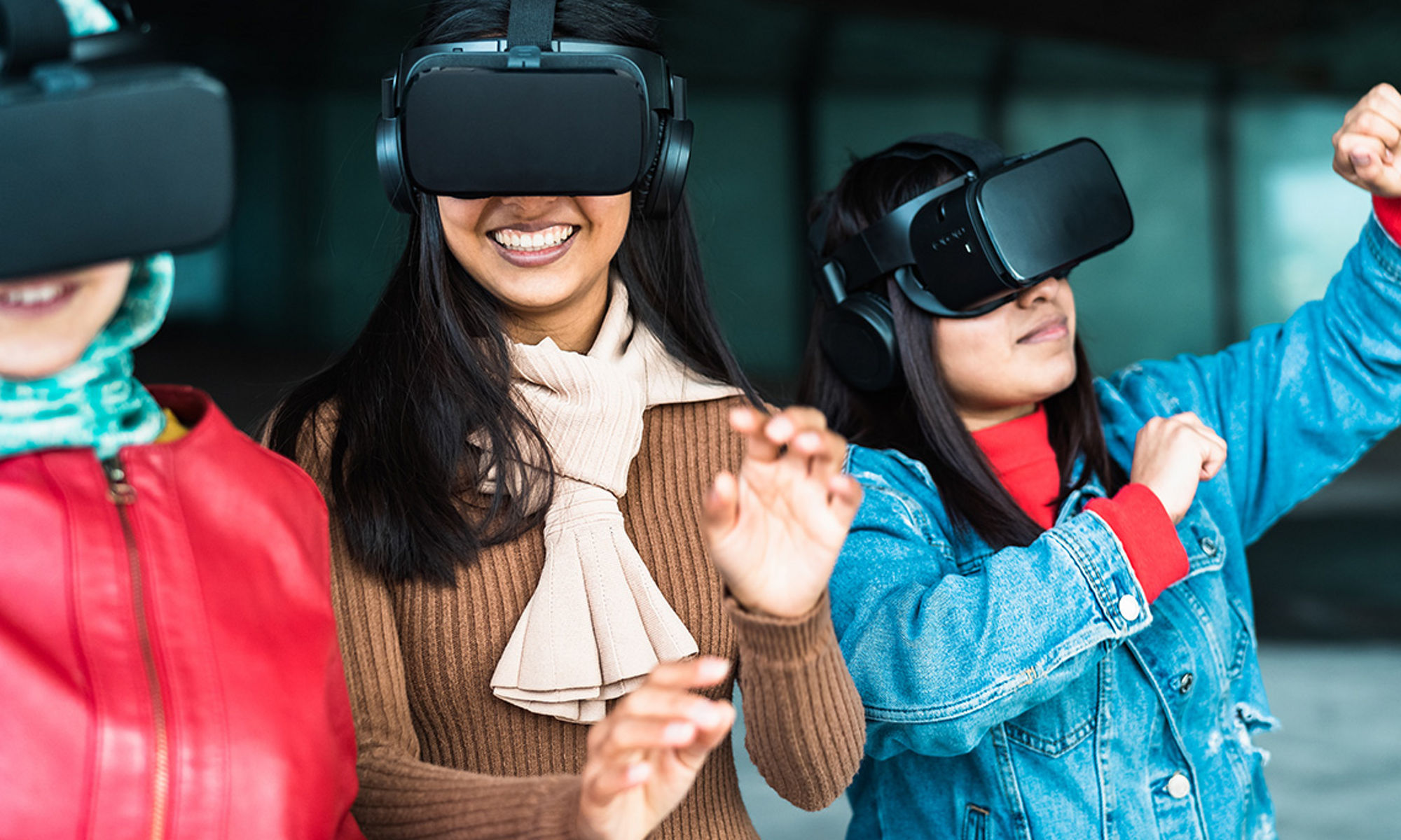 Group of three young people wearing vr headsets