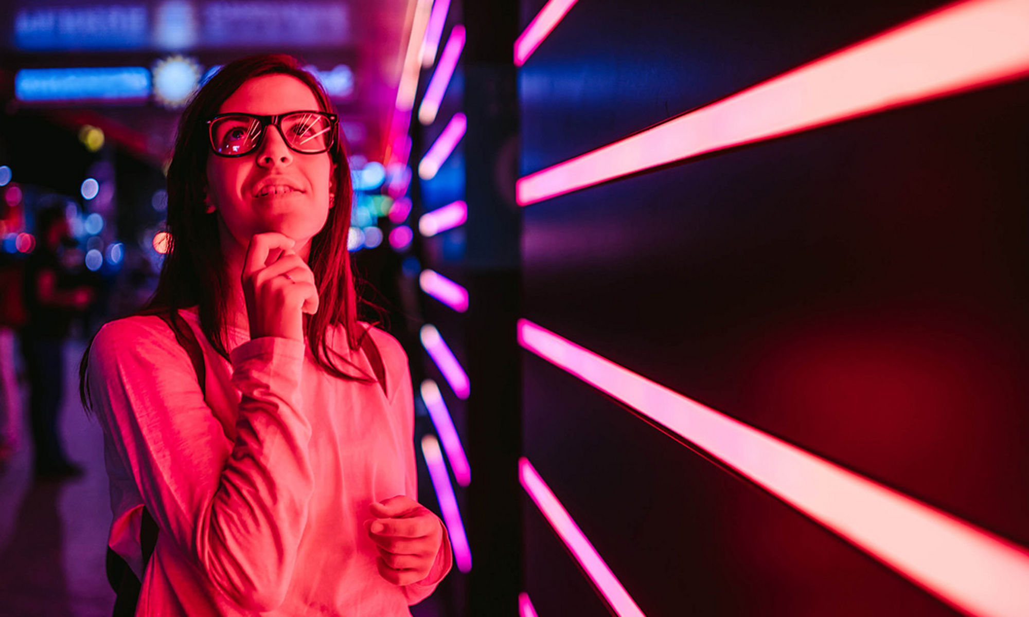 Women looking above with laser lights in the background