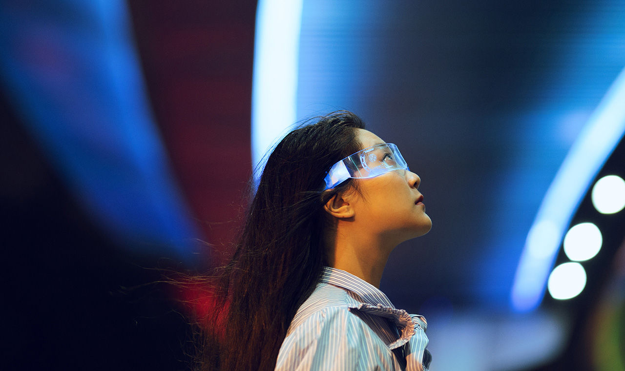 Woman looking up at interior lighted ceiling