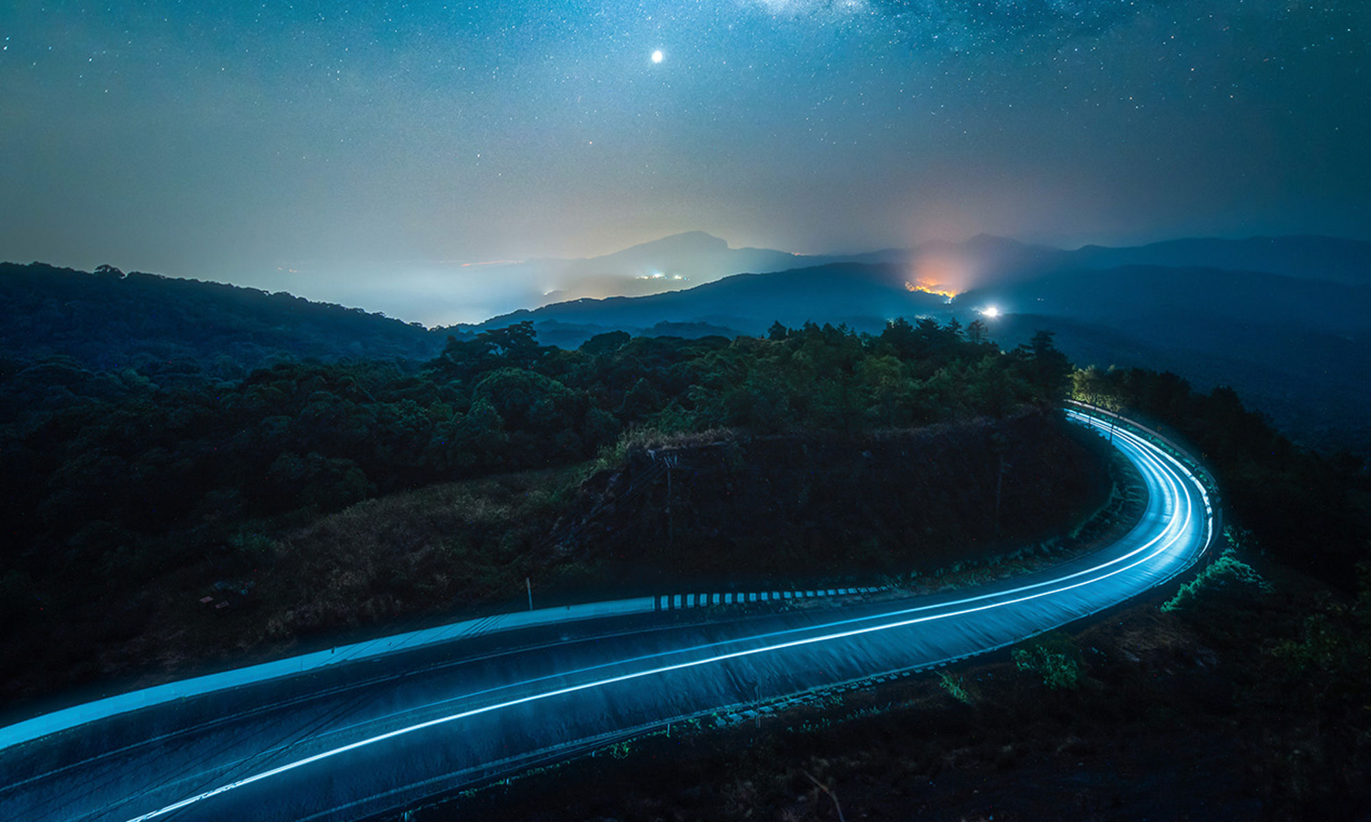 Road going off into the horizon, at night