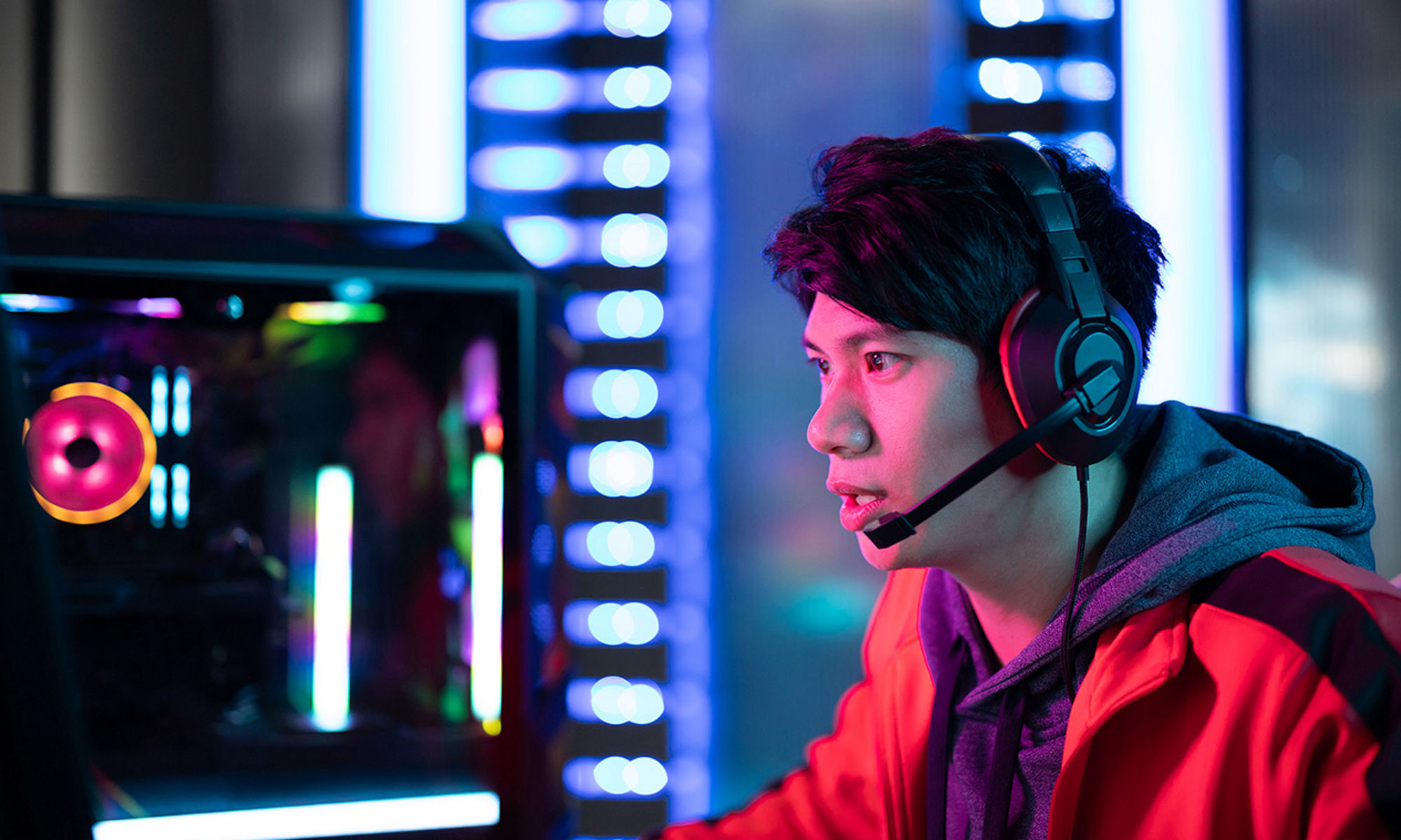 Young man with a headset on at a gaming computer