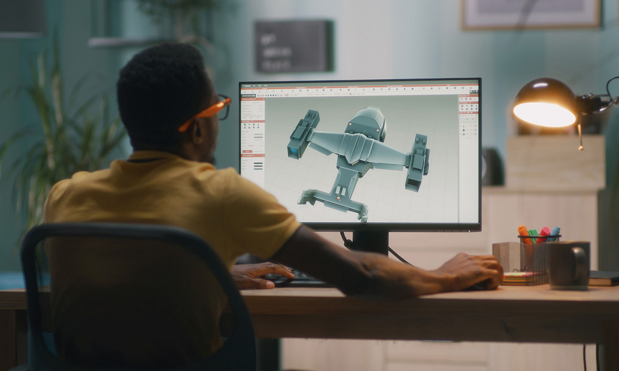 Man sitting in front of monitor loking at schematic