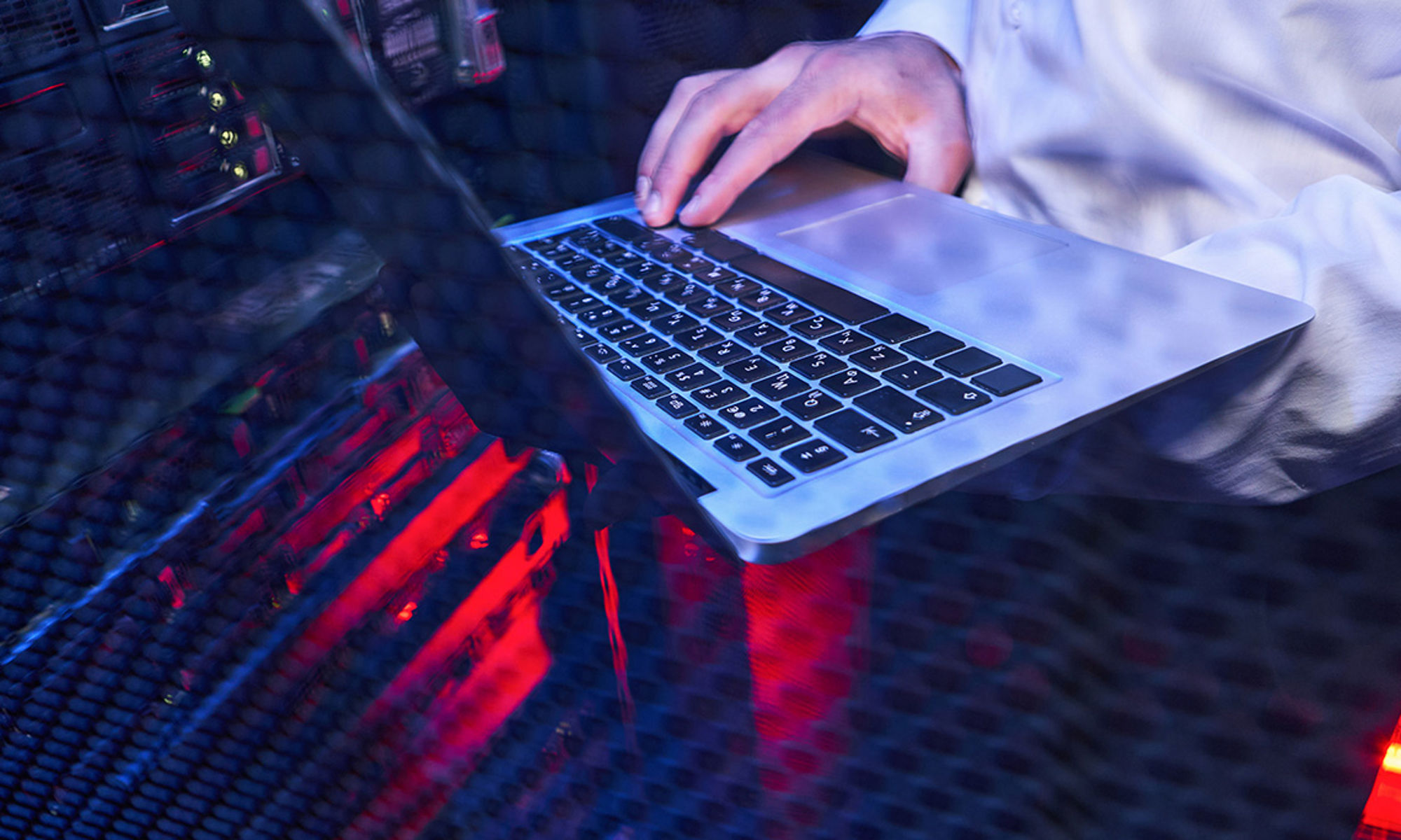 close up image of hands typing on laptop