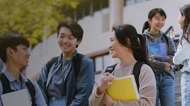 group of college students taking and smiling