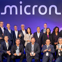 Group of people along with CEO Sanjay Mehrotra standing on the stage and posing for the awards ceremony