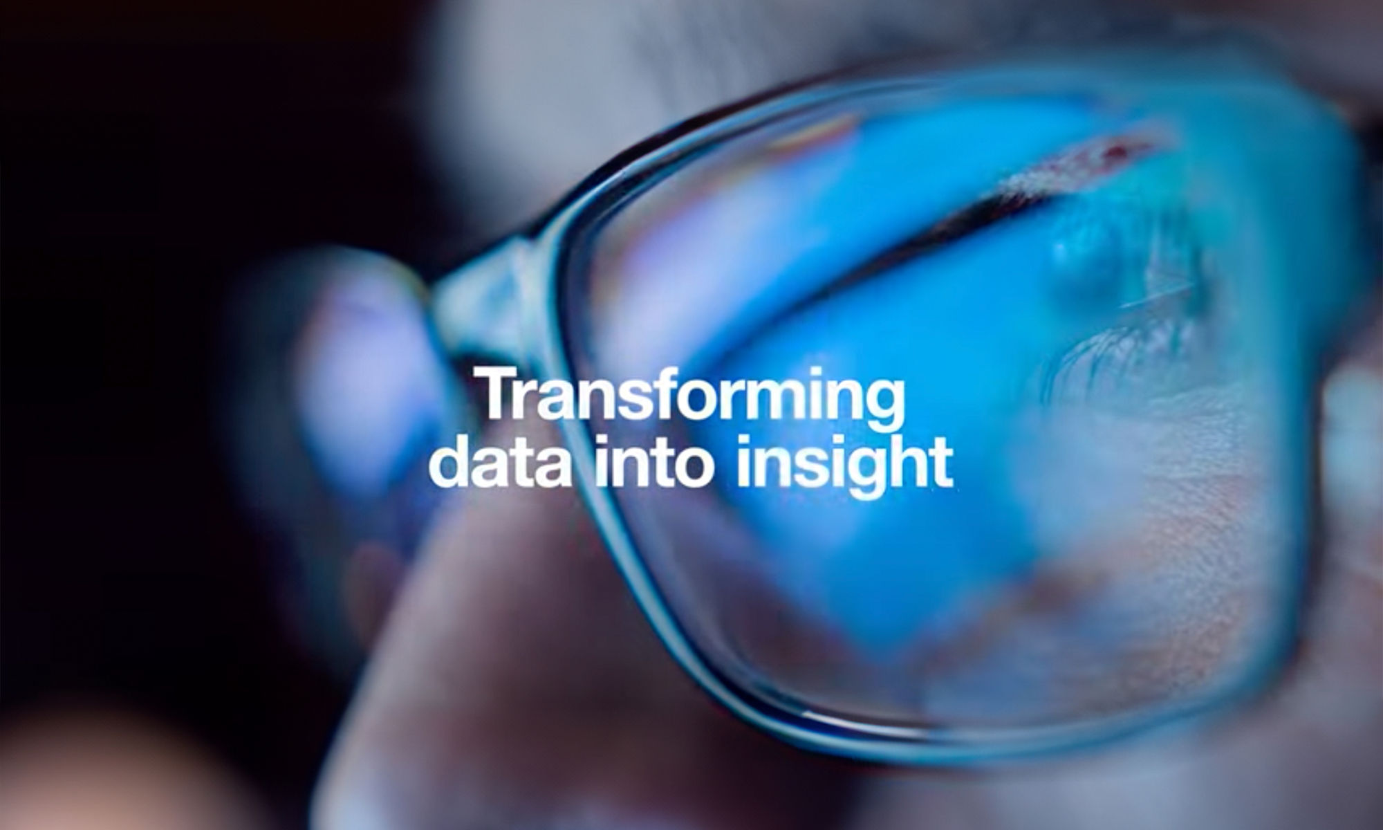 Transforming data into insight - man with blue lit glasses