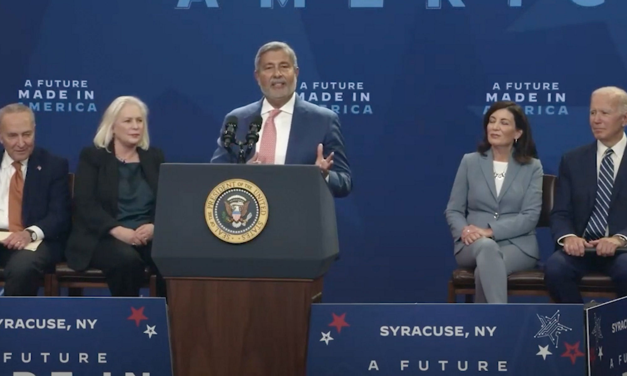 Sanjay Mehrotra speaking at President Joe Biden's podium