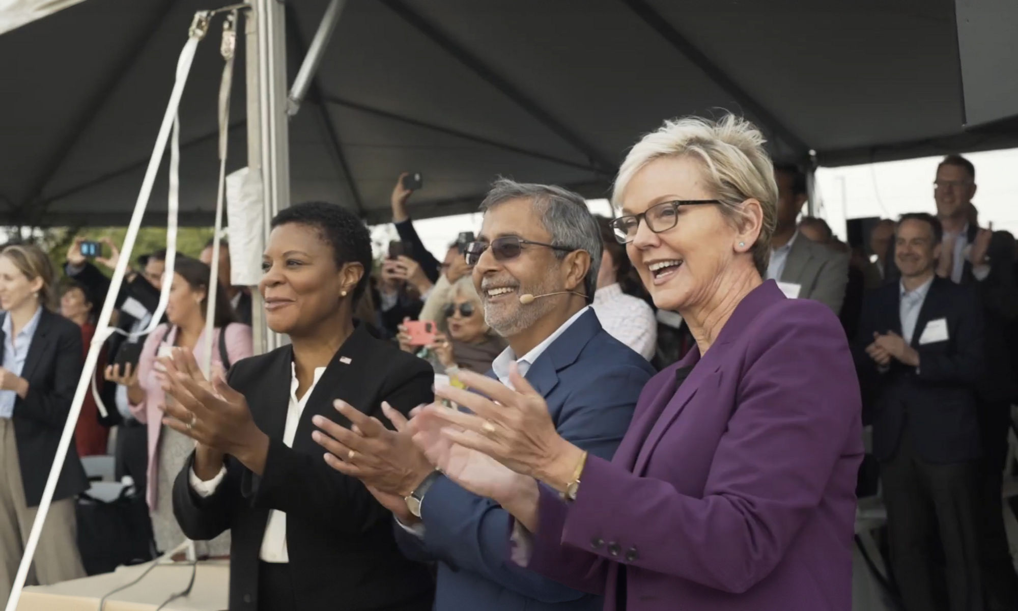 Executives and politicians clapping at ceremony