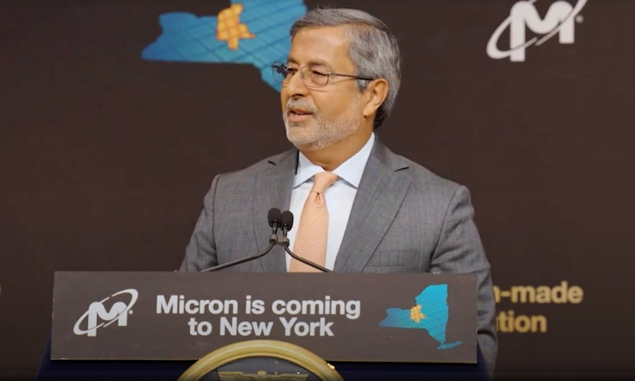 Sanjay Mehrotra speaking at President Joe Biden's podium